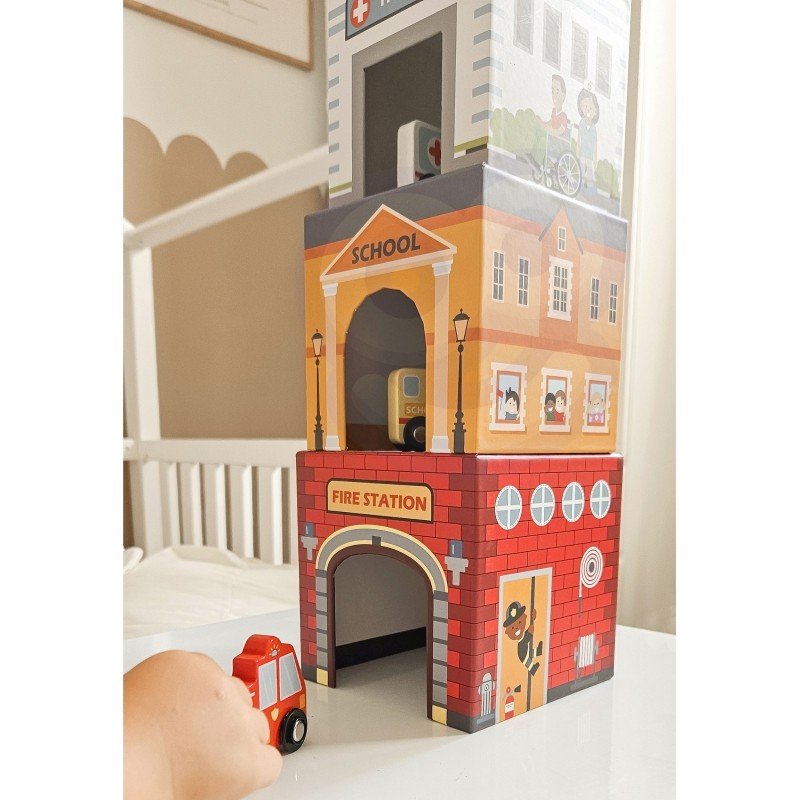 8. Close-up of colorful city-themed puzzle cubes stacked with a fire truck toy