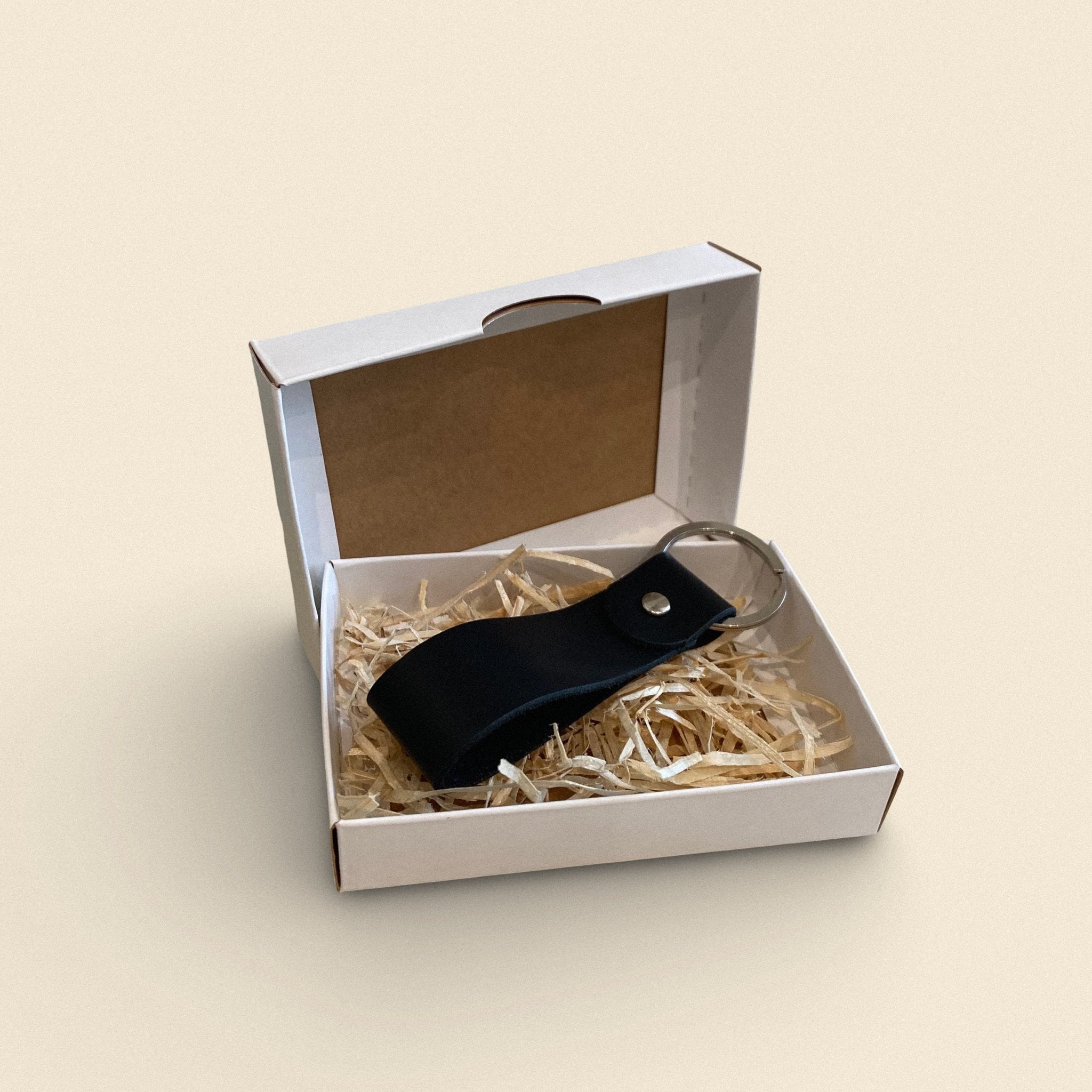 9. Black handmade leather keychain by Yoru in white gift box with straw filling