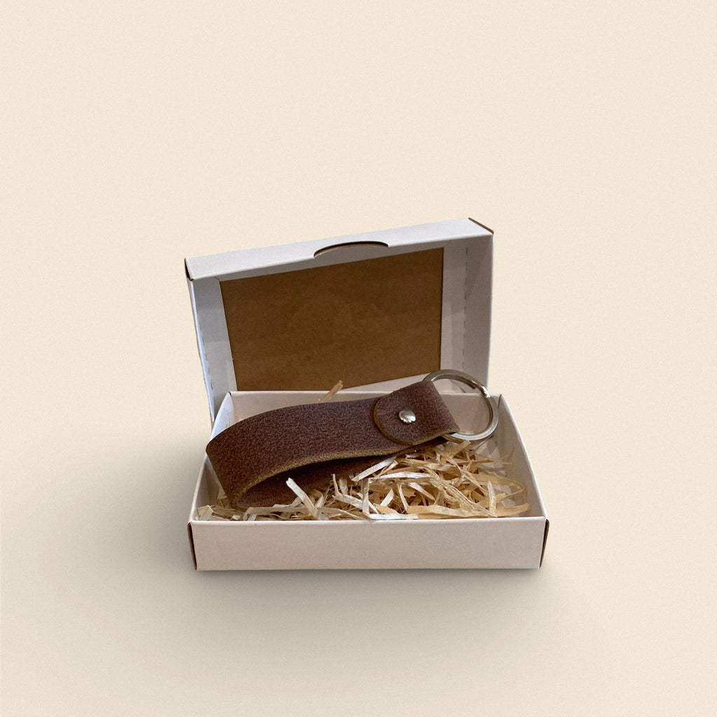 8. Dark brown handmade leather keychain by Yoru in white gift box with straw filling