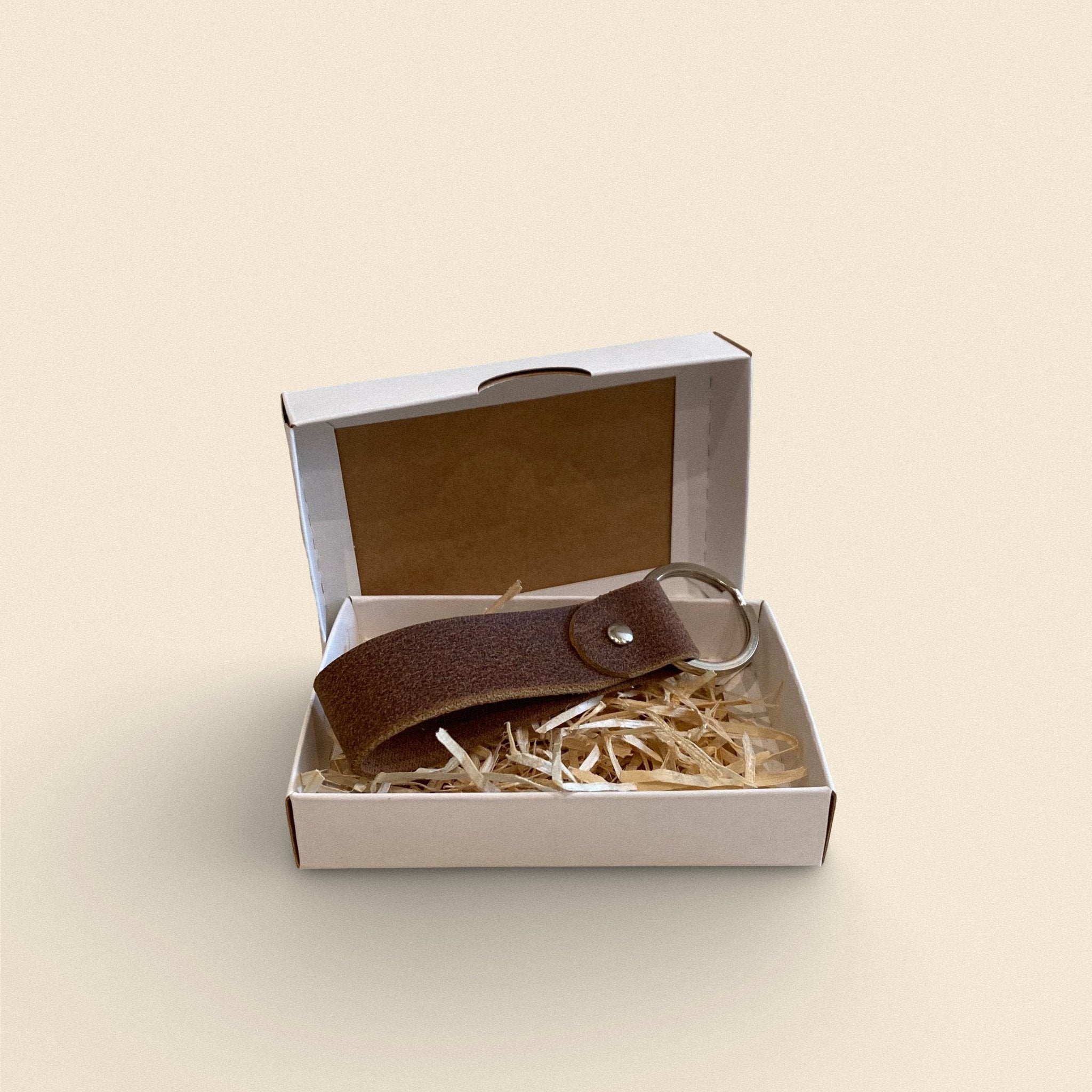 8. Dark brown handmade leather keychain by Yoru in white gift box with straw filling