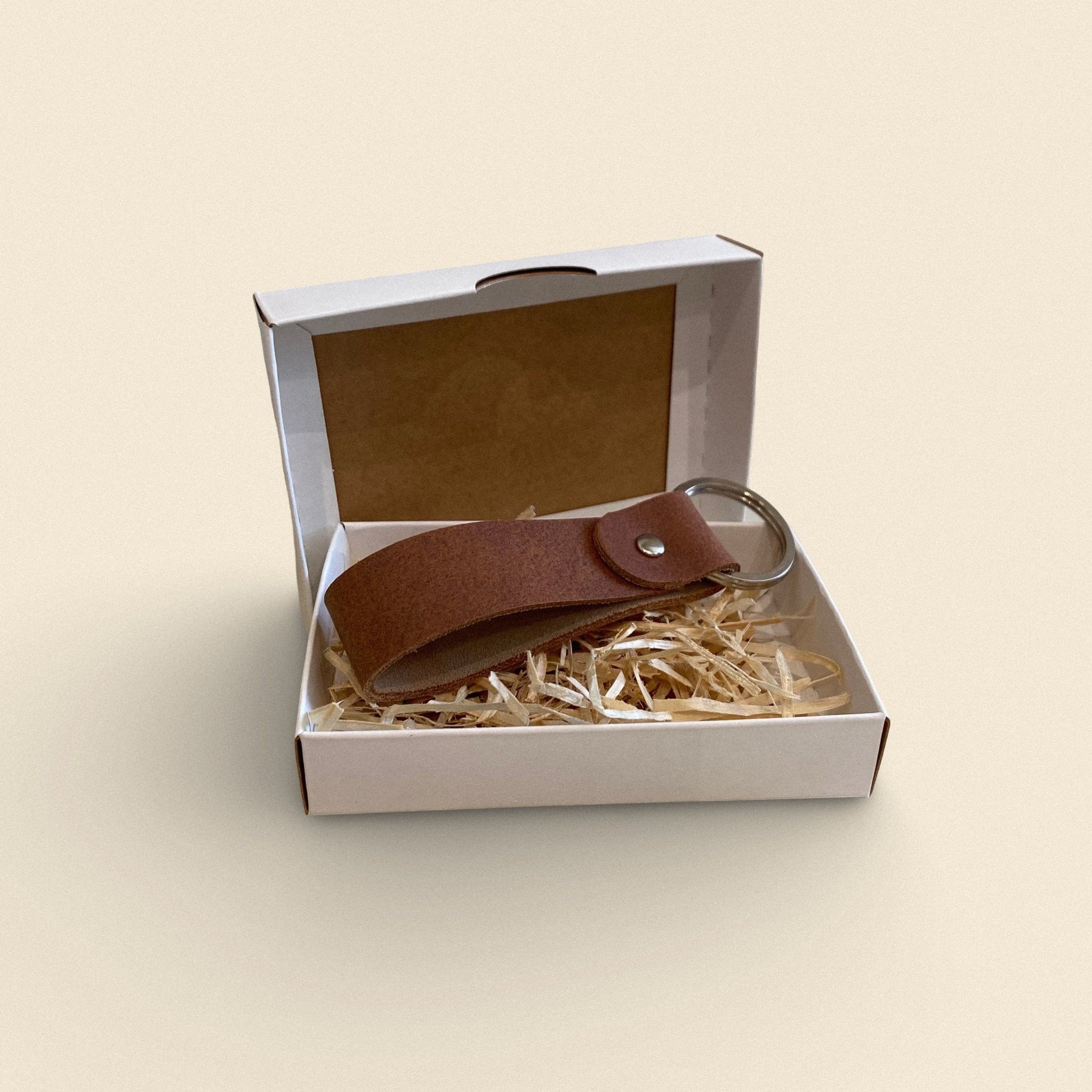 6. Light brown handmade leather keychain by Yoru in white gift box with straw filling