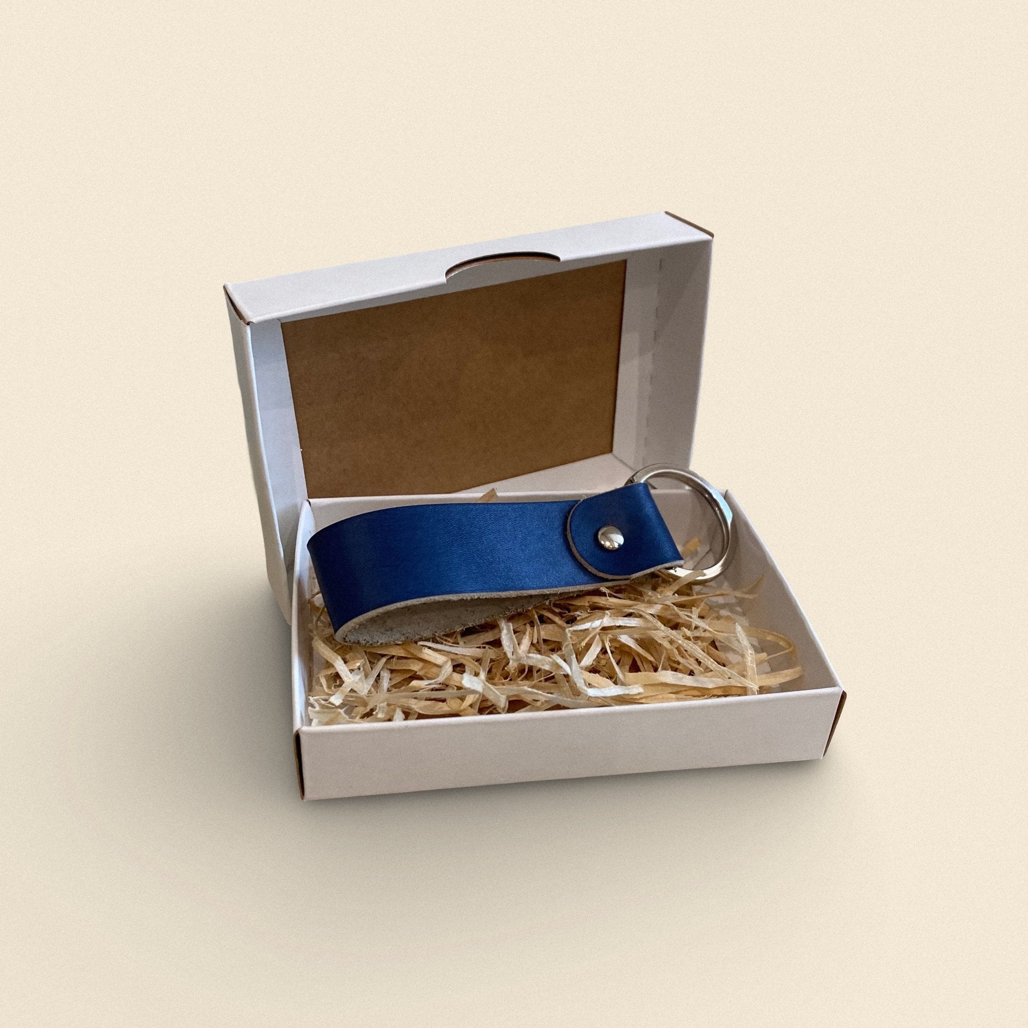 5. Navy blue handmade leather keychain by Yoru in white gift box with straw filling