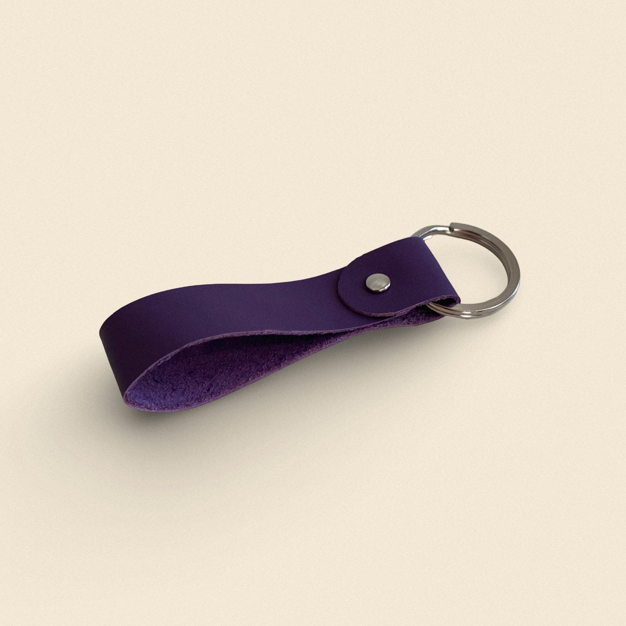 11. Violet handmade leather keychain by Yoru with metal ring on beige background