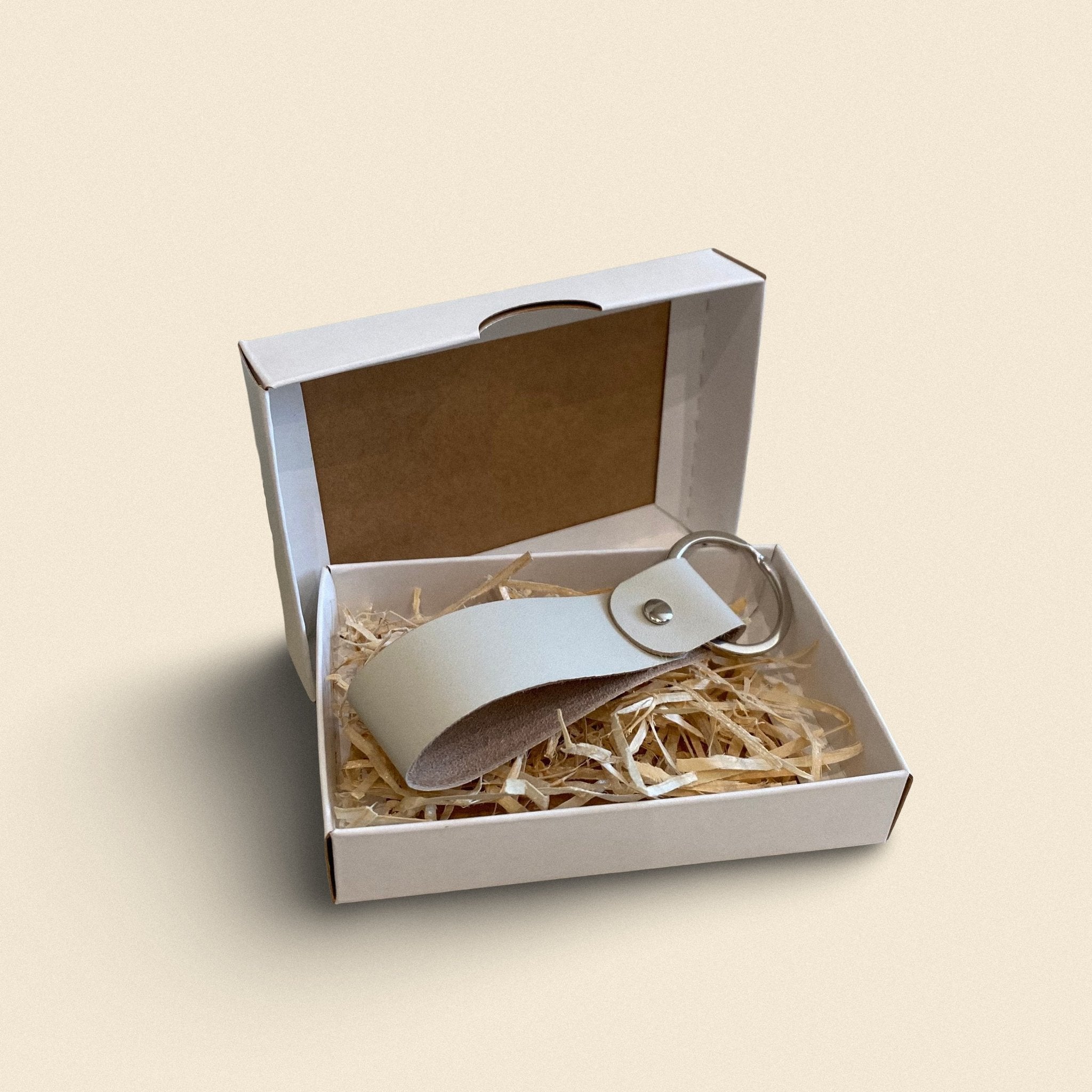10. White handmade leather keychain by Yoru in white gift box with straw filling