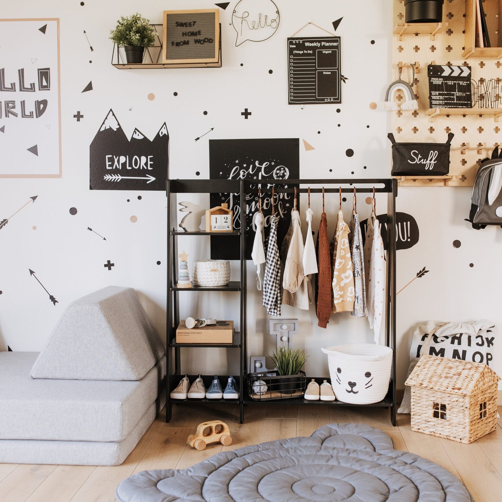 4. Black clothing rack with toddler clothes and toys in a stylish children's room