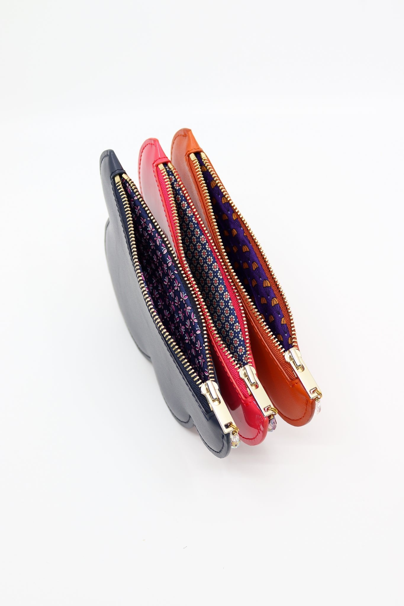 6. Close-up of Tairi Roosve Leather Cloud Purses in various colors, highlighting unique silk linings and Excella zips