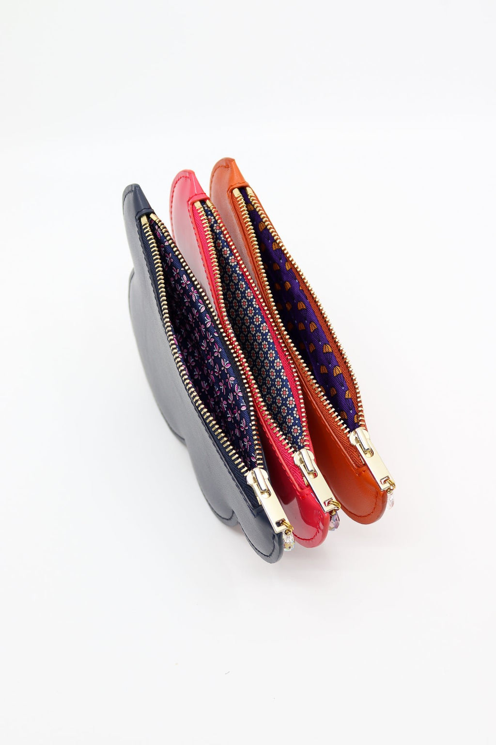 4. Close-up of Tairi Roosve cloud purses in pink, orange, and gray with repurposed silk linings