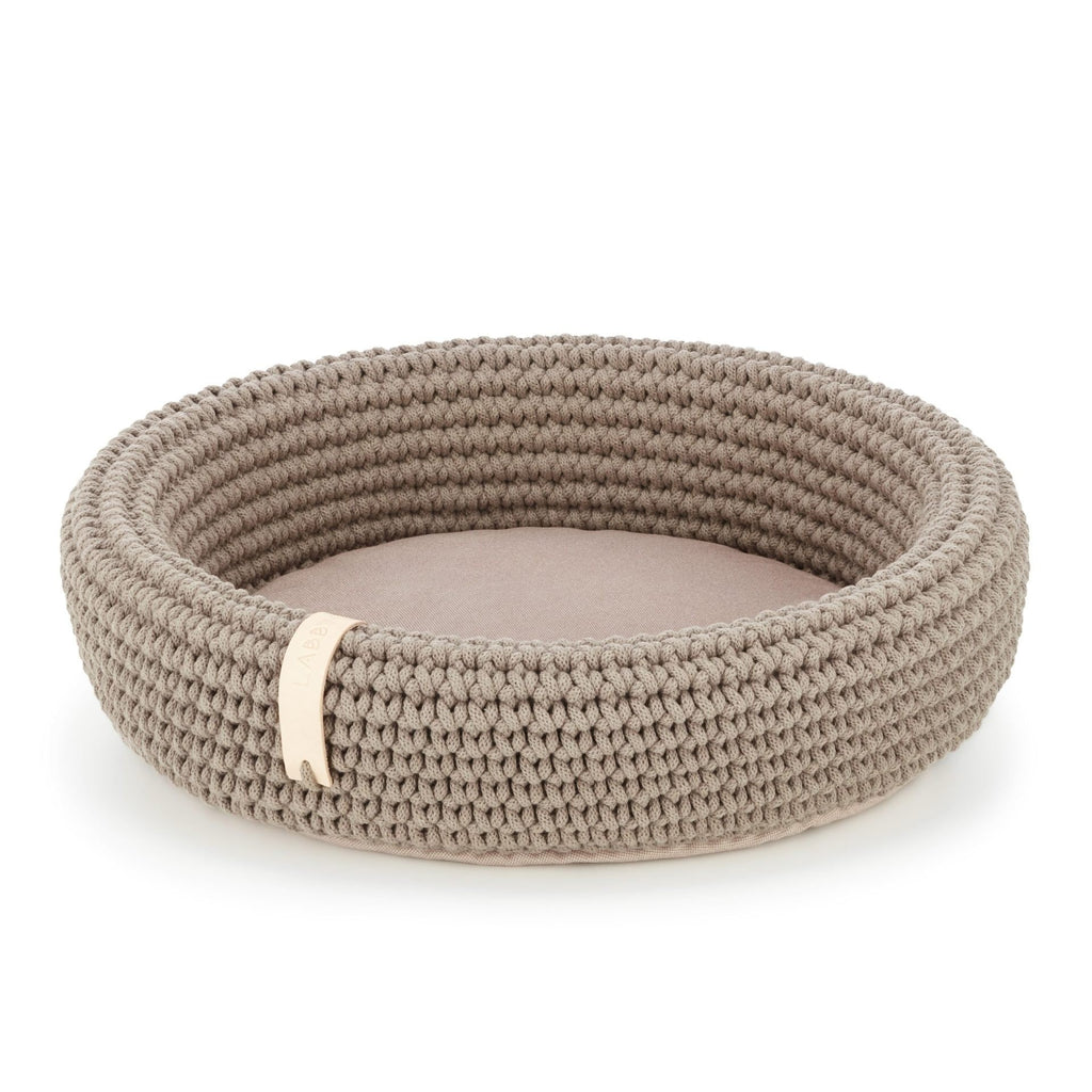 2. Light brown hand-woven pet bed made from Oeko-Tex cotton rope with soft pillow bottom, shown in studio setting