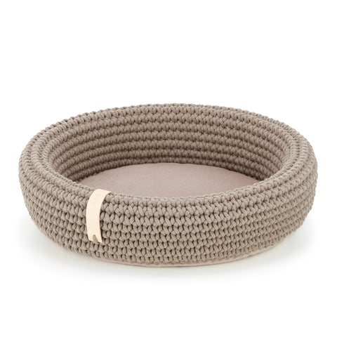 2. Light brown hand-woven pet bed made from Oeko-Tex cotton rope with soft pillow bottom, shown in studio setting
