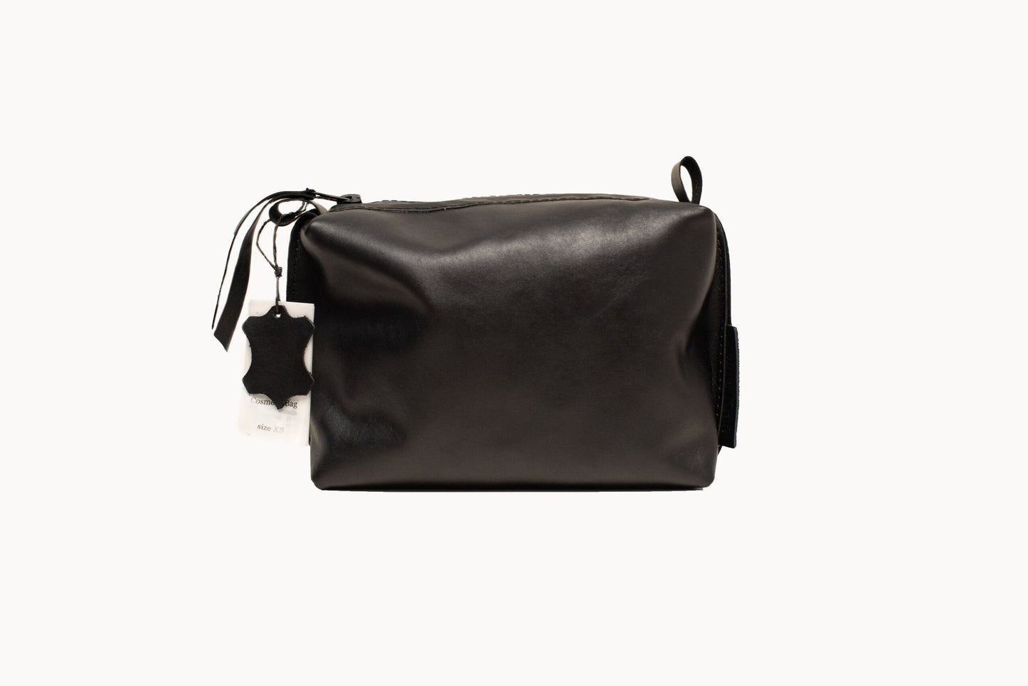 5. Studio image of Zelma Kraft black leather cosmetic bag with zipper closure and tag