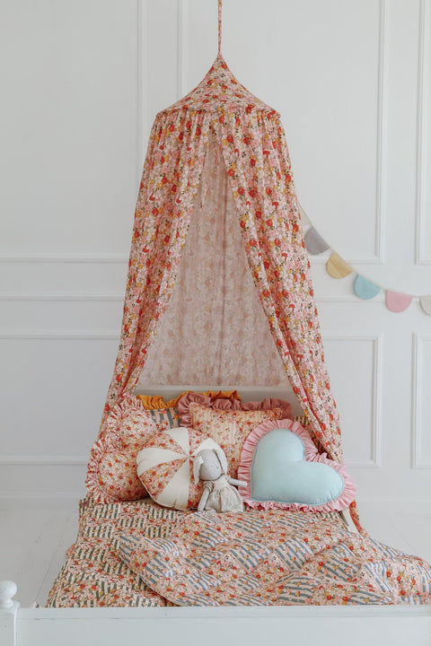 3. Children's bed with cotton quilted patchwork blanket and pillow set under a floral canopy