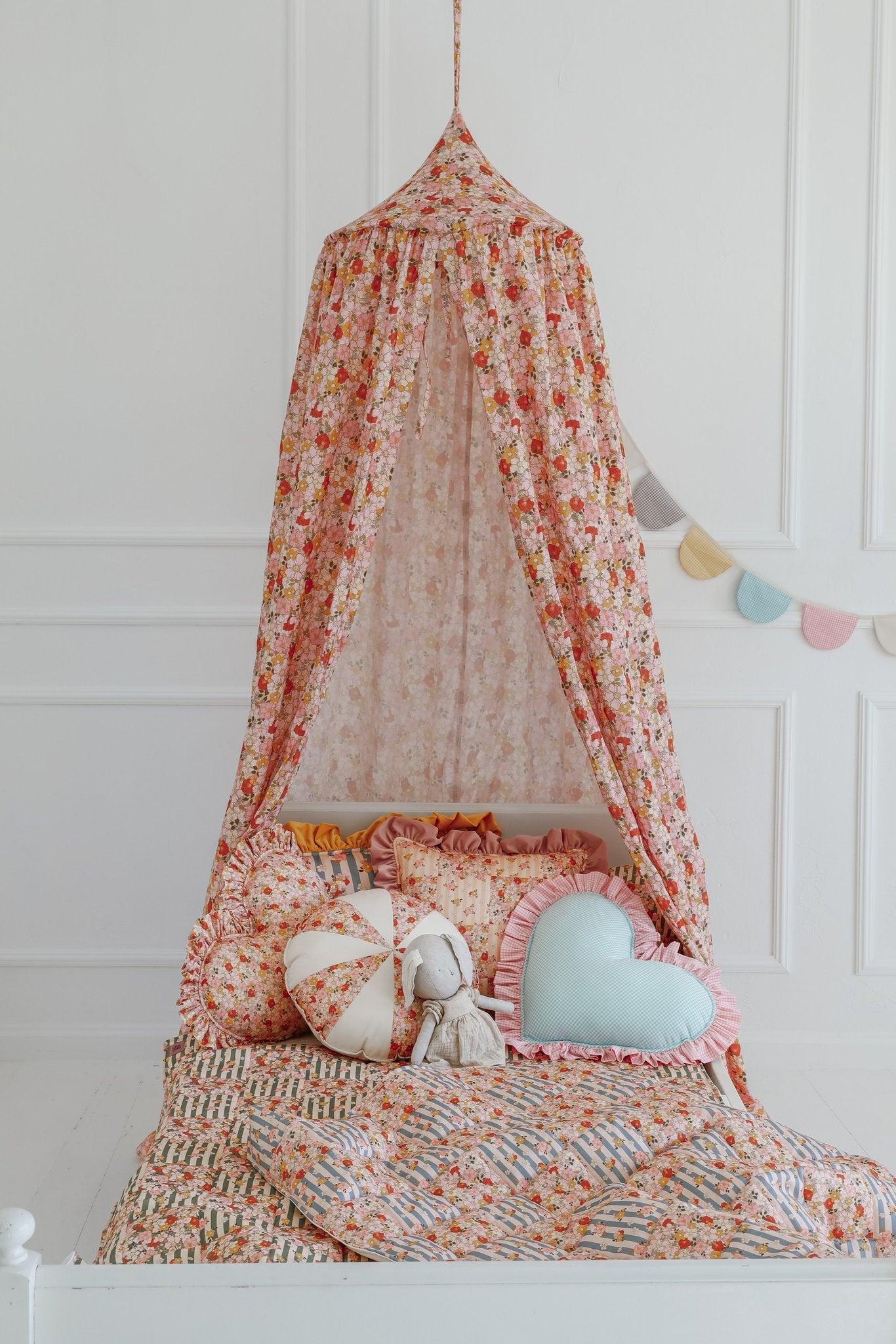 5. Children's bed with Moi Mili cotton quilted patchwork blanket and canopy in floral design
