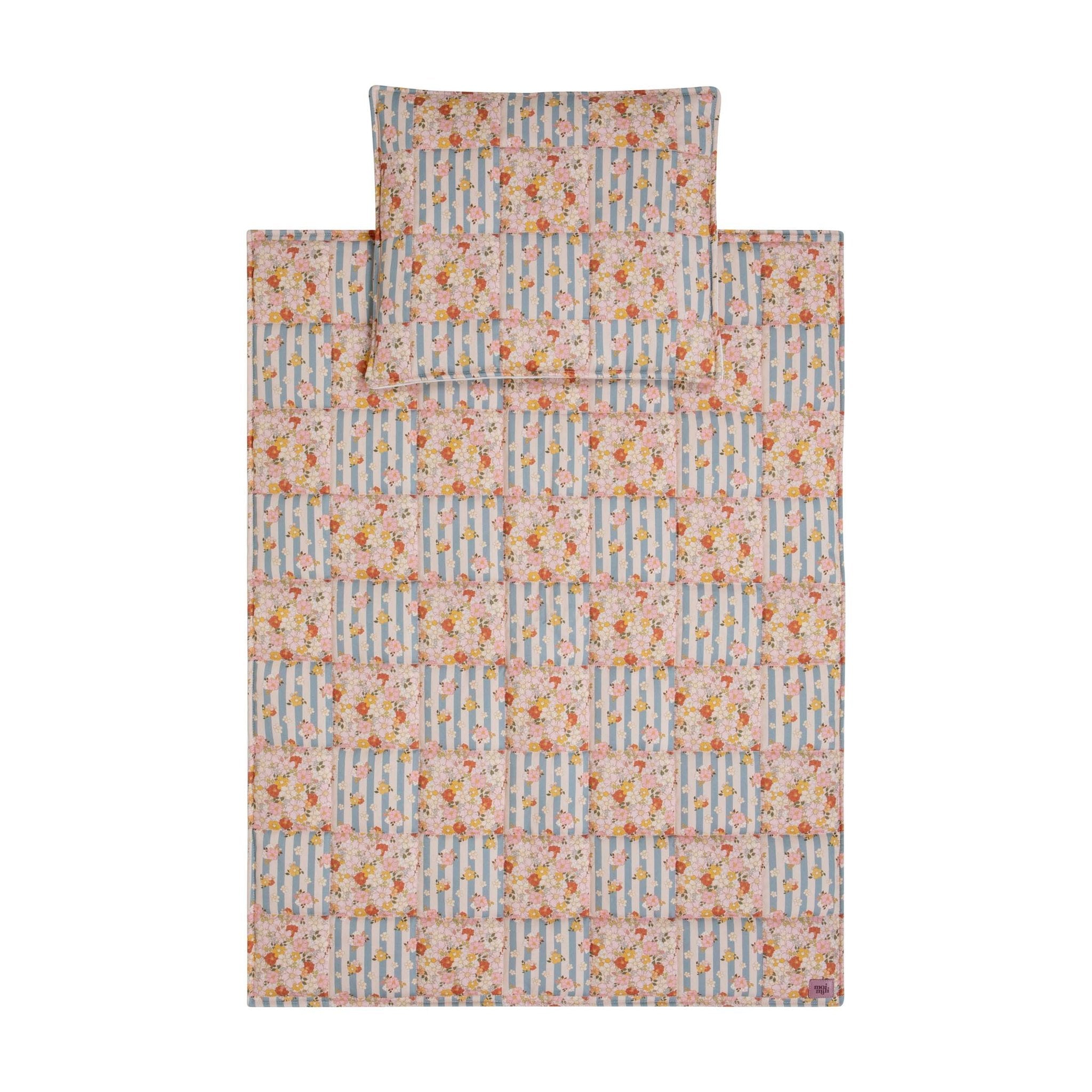 6. Flat lay of cotton quilted patchwork blanket and pillow set with floral and striped design