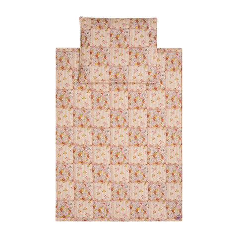 2. Studio shot of cotton quilted patchwork blanket and pillow set in floral pattern