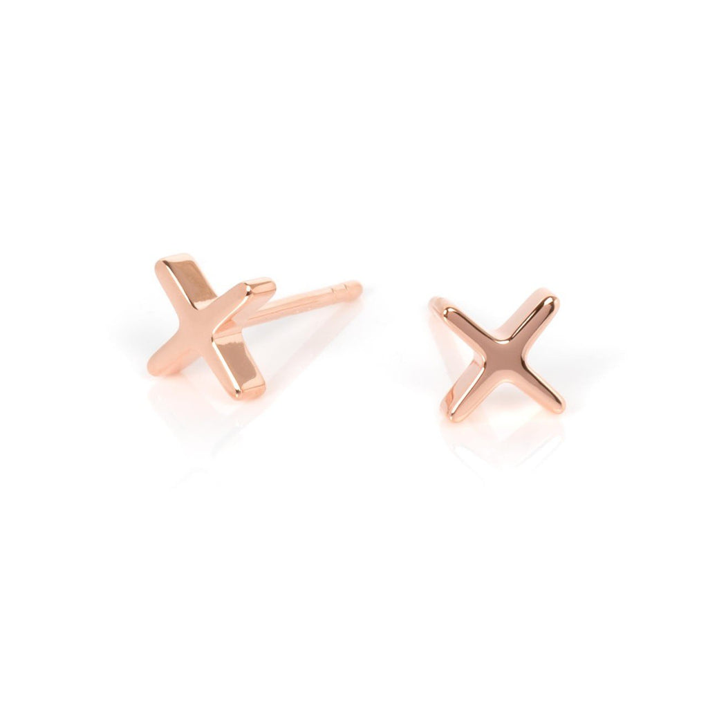 2. Pair of rose gold Crux earrings in cross shape on white background