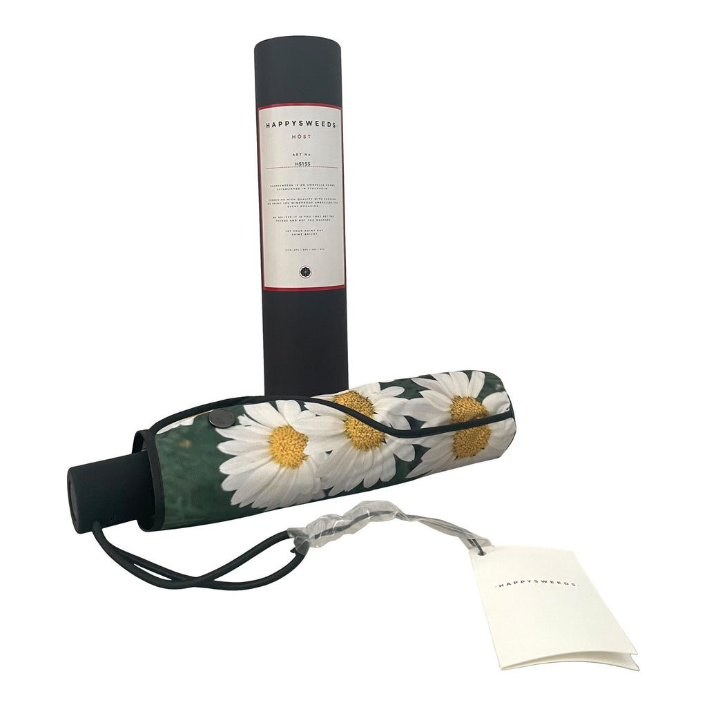 3. Close-up of folded daisy umbrella with floral cover and HAPPYSWEEDS packaging