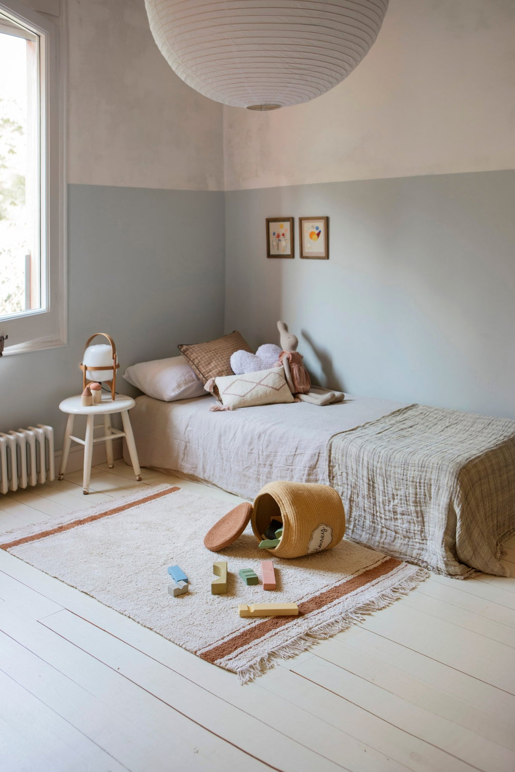 3. Children's room with honey yellow basket labeled 'Honey' on floor, surrounded by toys and neutral decor