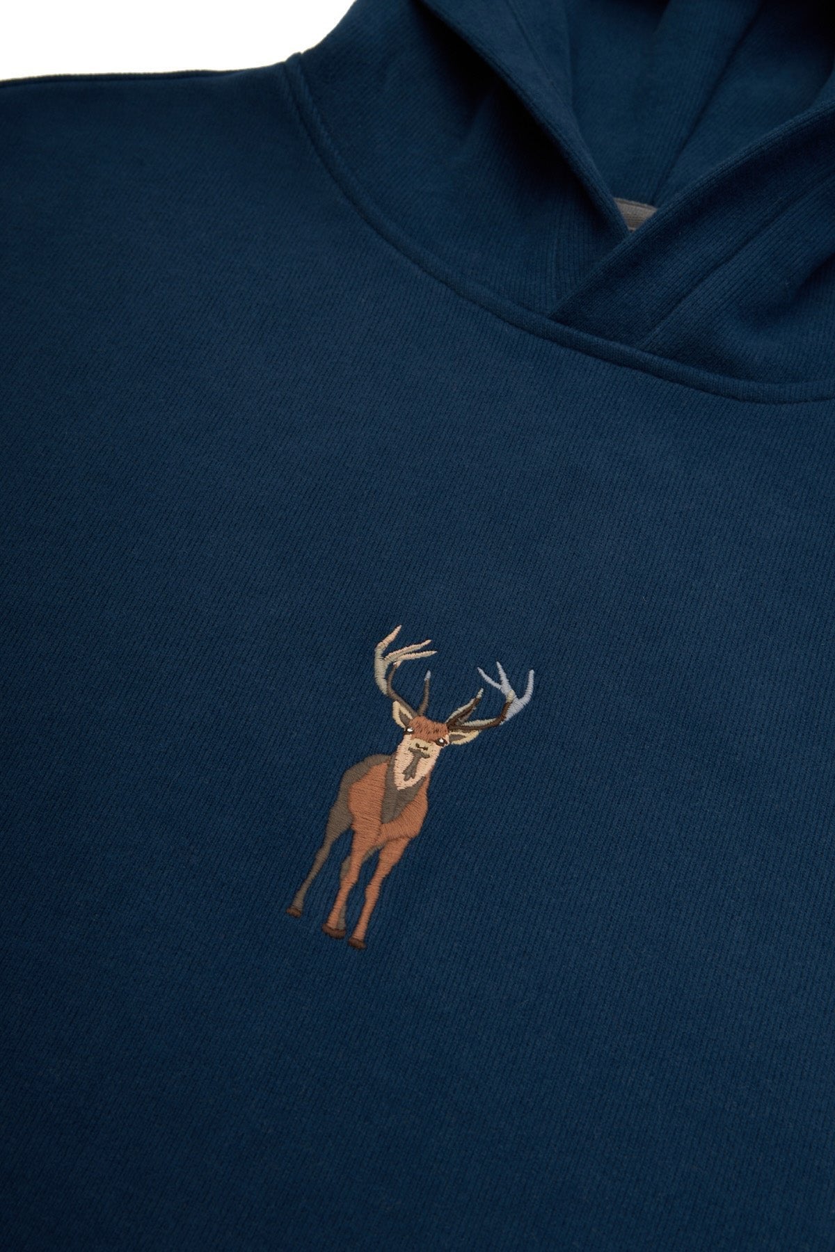 3. Close-up of embroidered deer design on Indigo Blue Sossu hoodie