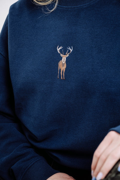 2. Close-up of unisex indigo blue Deer Sweatshirt by Sossu, highlighting embroidered deer design