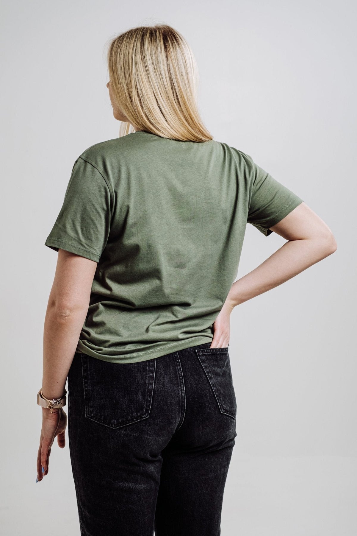 6. Back view of unisex khaki Deer T-shirt by Sossu worn by female model, showing relaxed fit