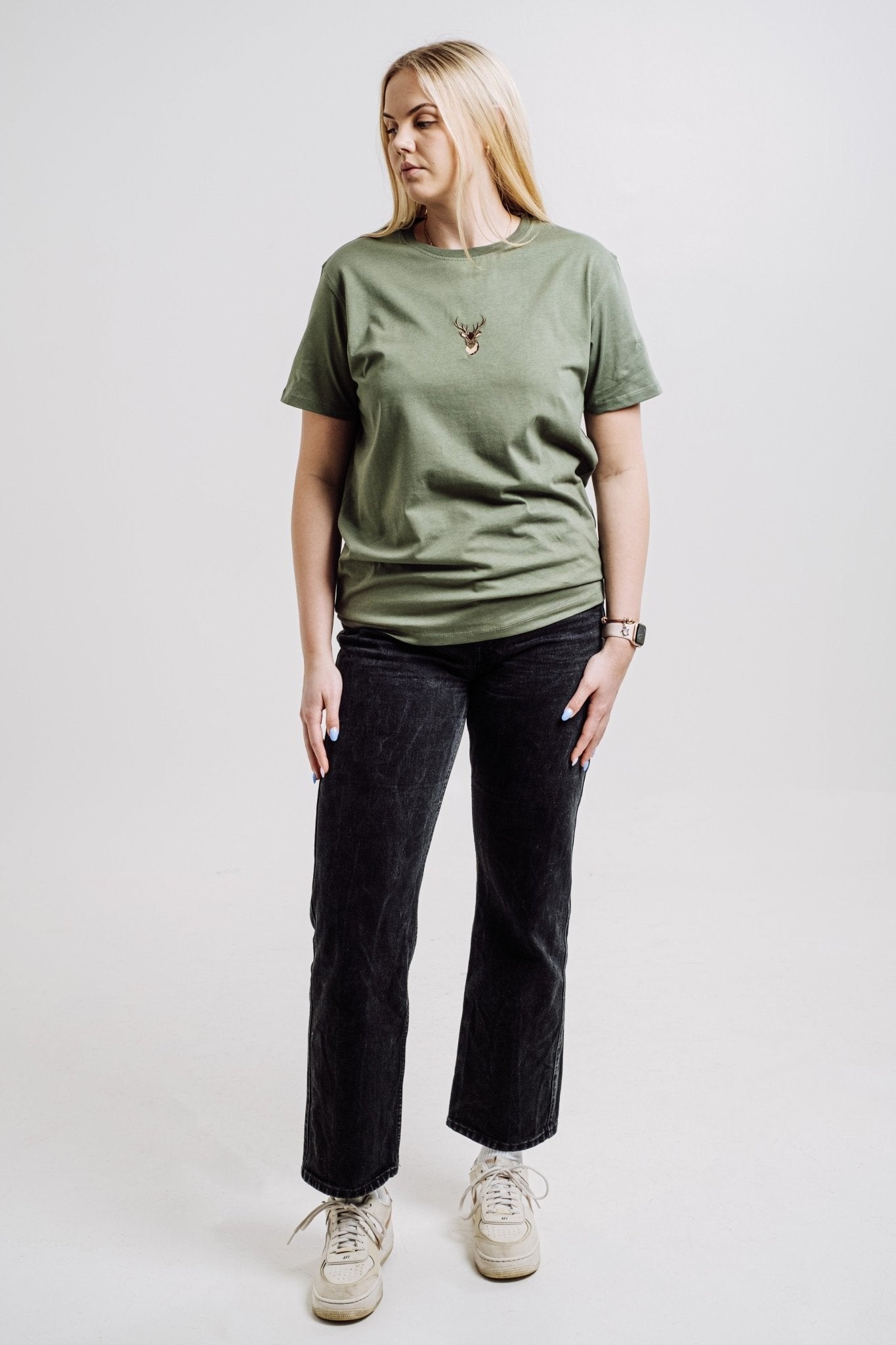 4. Unisex khaki Deer T-shirt by Sossu worn by female model, full body view in studio setting
