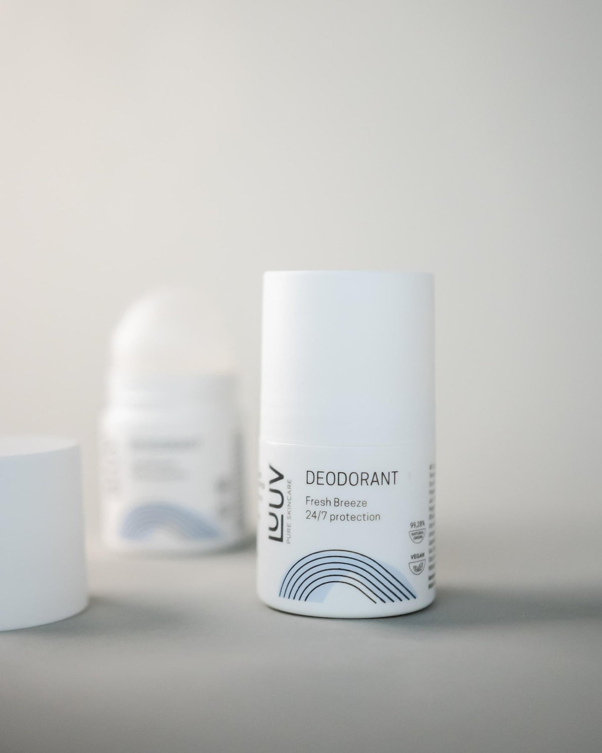 1. LUUV Fresh deodorant bottle with Fresh Breeze 24/7 protection label on a light background, featuring minimalist design and blue wave graphic