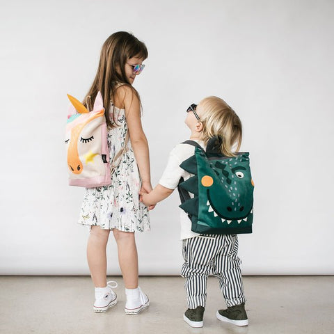 1. Kids wearing Muni dinosaur and unicorn backpacks, lifestyle setting