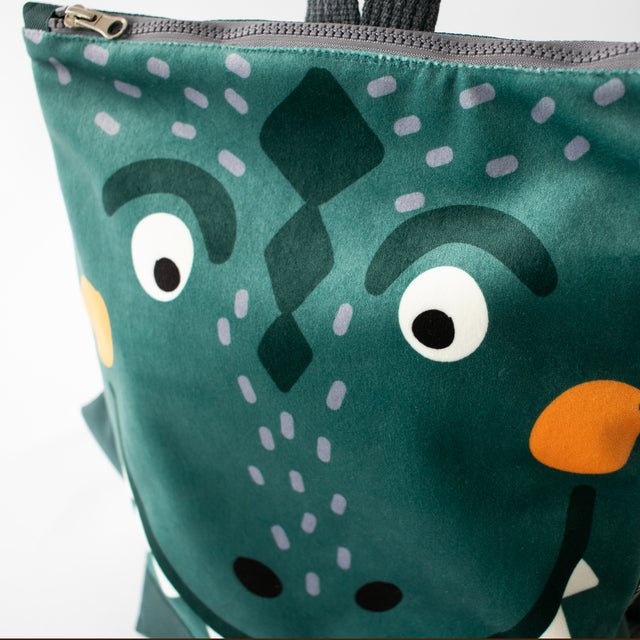 13. Close-up of Muni dinosaur backpack highlighting face design