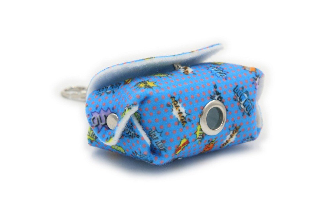 6. Close-up of blue graffiti dog waste bag dispenser with metal eyelet and comic motifs, highlighting felt material.