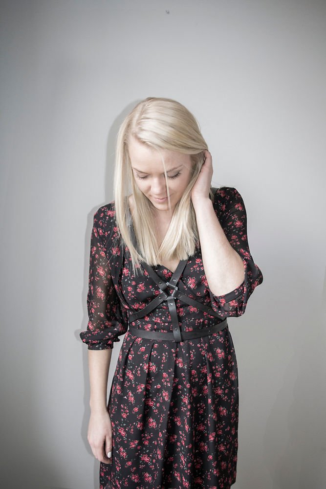 1. Woman wearing RR Body Harness No 5 over floral dress, showcasing versatile style
