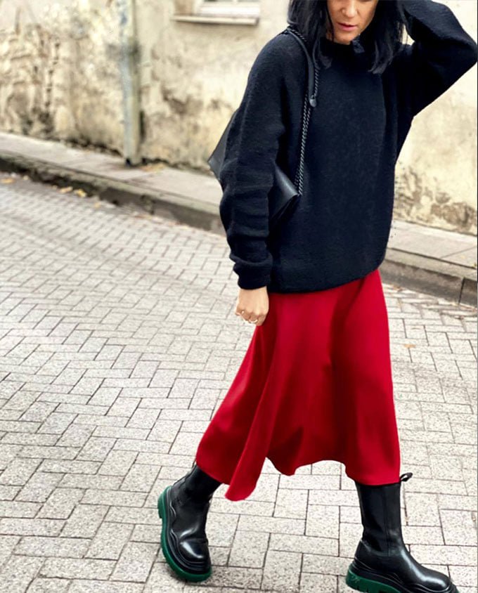 4. Woman walking with RR black matte leather chain shoulder bag styled with red skirt