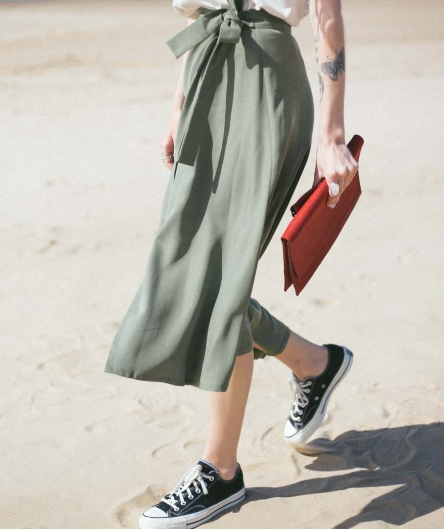 12. Woman holding RR dark brown chain shoulder bag, styled with taupe dress and cardigan