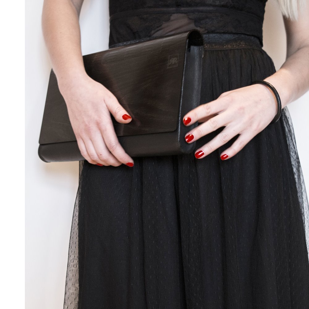 3. Woman in red coat holding large glossy wood clutch by RR, street style setting