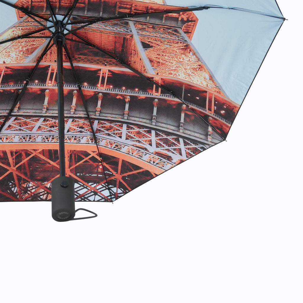 7. Close-up of Eiffel Umbrella's Eiffel Tower print and automatic handle, showcasing design details