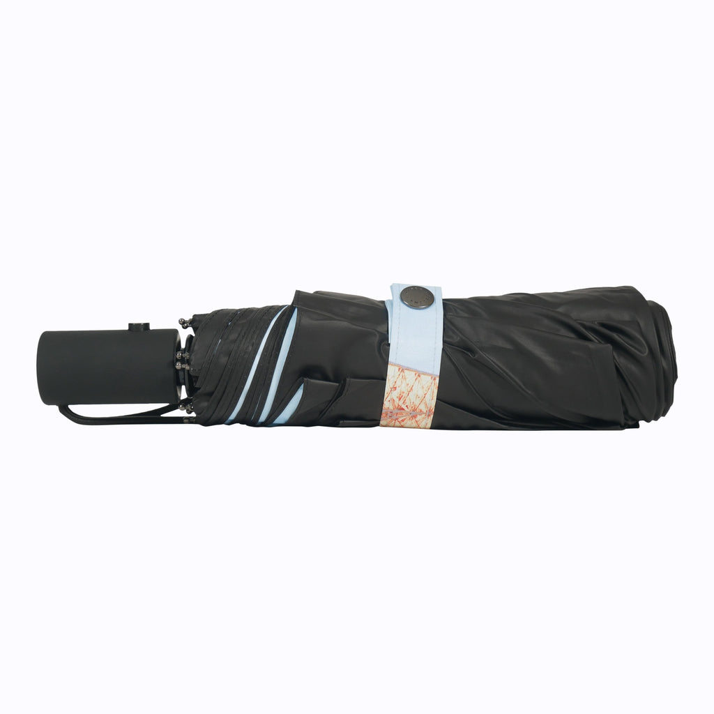8. Eiffel Umbrella folded in black cover with button closure, emphasizing compact and convenient design