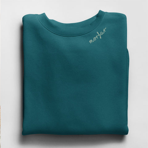 2. Teal sweatshirt with light gray 'Morfar' embroidery on collar folded on a white background