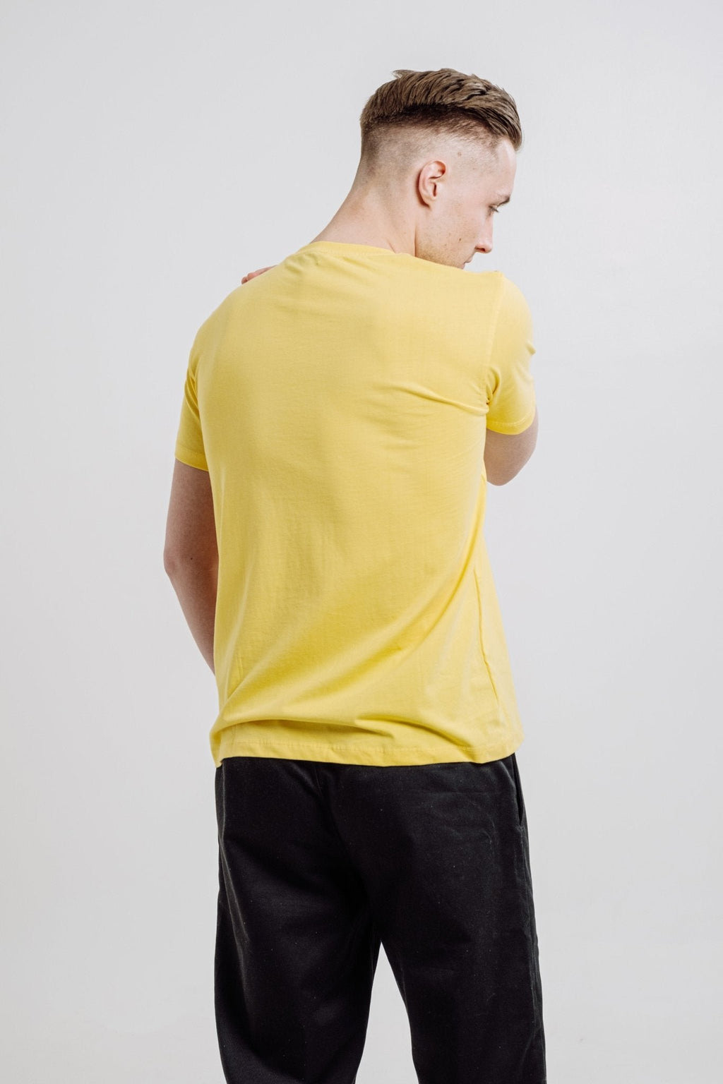 2. Back view of unisex yellow Emperor Penguin T-shirt by Sossu, highlighting relaxed fit