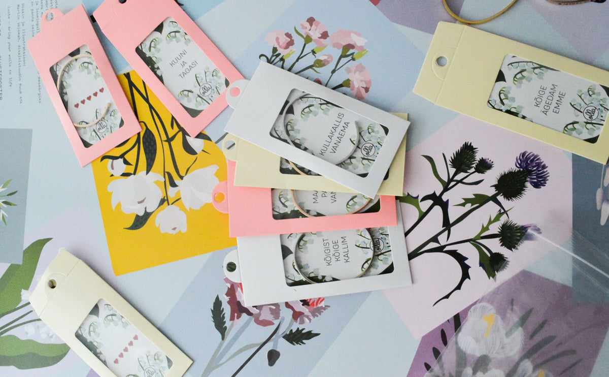 4. Collection of 'The Coolest Mommy' bracelet packaging by Olla, displayed on floral background