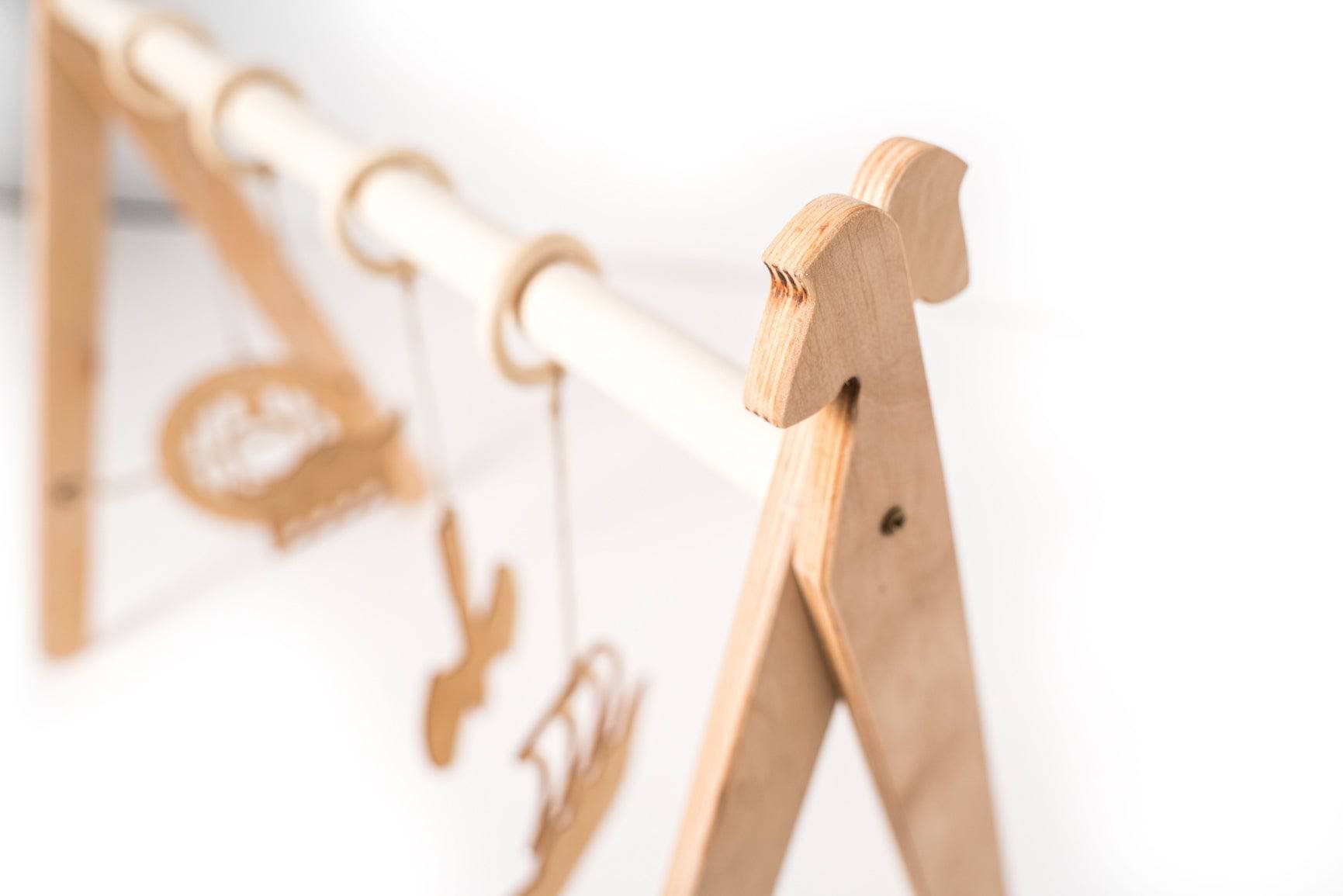 3. Detail of wooden play gym frame with Viking-themed design elements