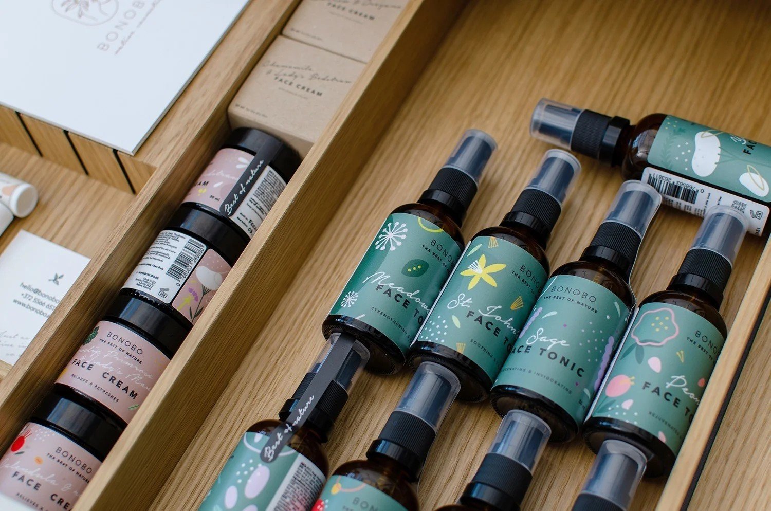 2. Collection of Bonobo face tonics and creams in wooden drawer, showcasing various labels and packaging designs