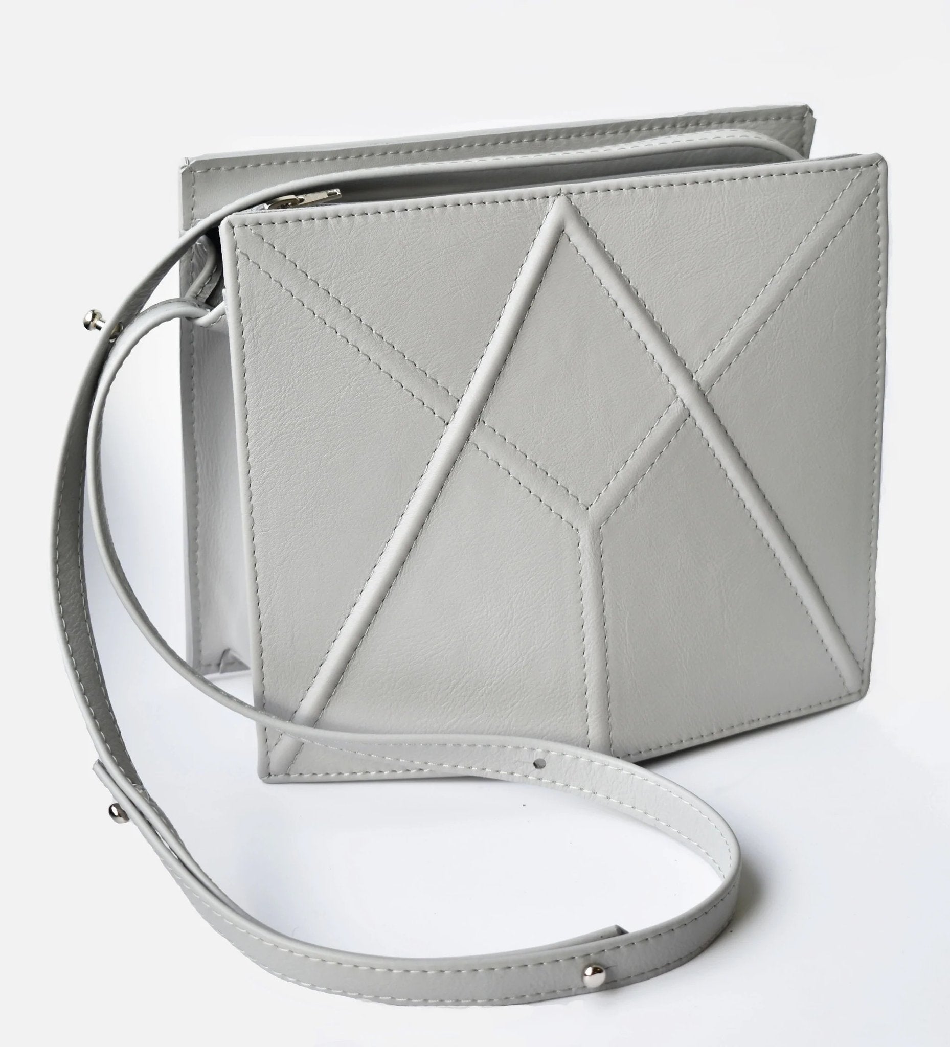 4. Grey FACET shoulder bag by Gerda Retter Design in studio setting, showing adjustable strap and geometric pattern