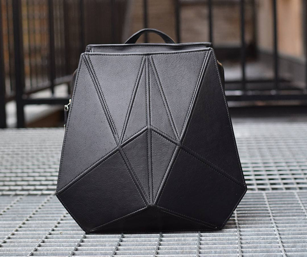 4. Studio shot of Gerda Retter Design FACET black leather backpack, emphasizing quality Spanish leather and unique shape