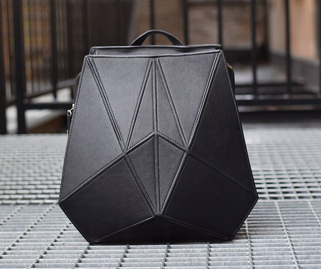 4. Studio shot of Gerda Retter Design FACET black leather backpack, emphasizing quality Spanish leather and unique shape