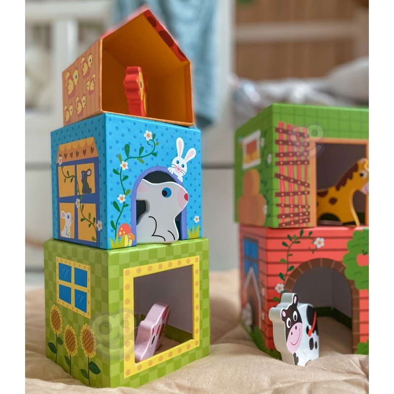 5. Colorful cubes with animal illustrations and wooden figurines on a beige surface