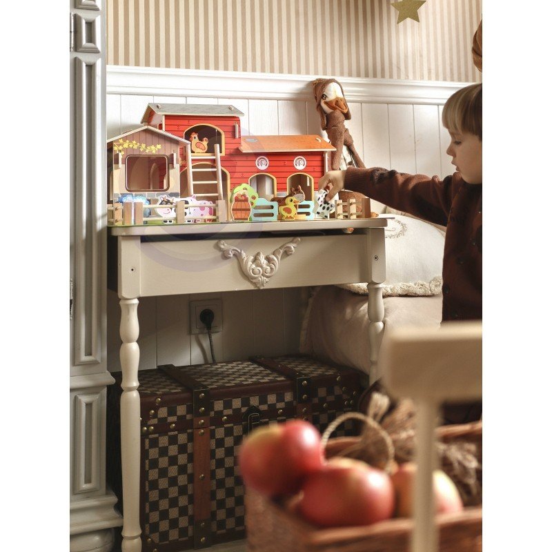 2. Child interacting with Woopie Green Mega Farm set on a table, showcasing barn and animal figurines in a cozy room