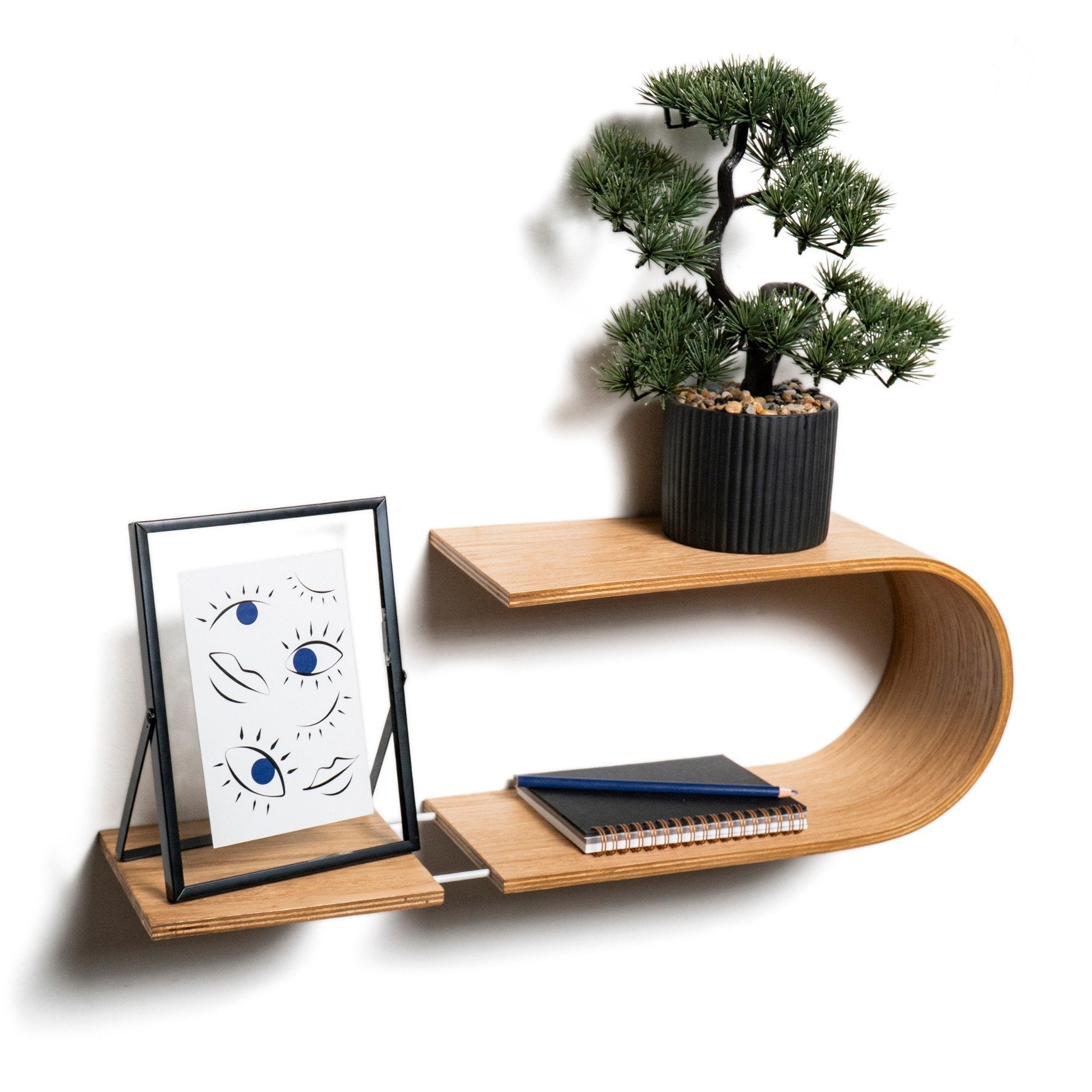 1. Oval wooden wall shelf with bonsai and framed art, styled for modern home