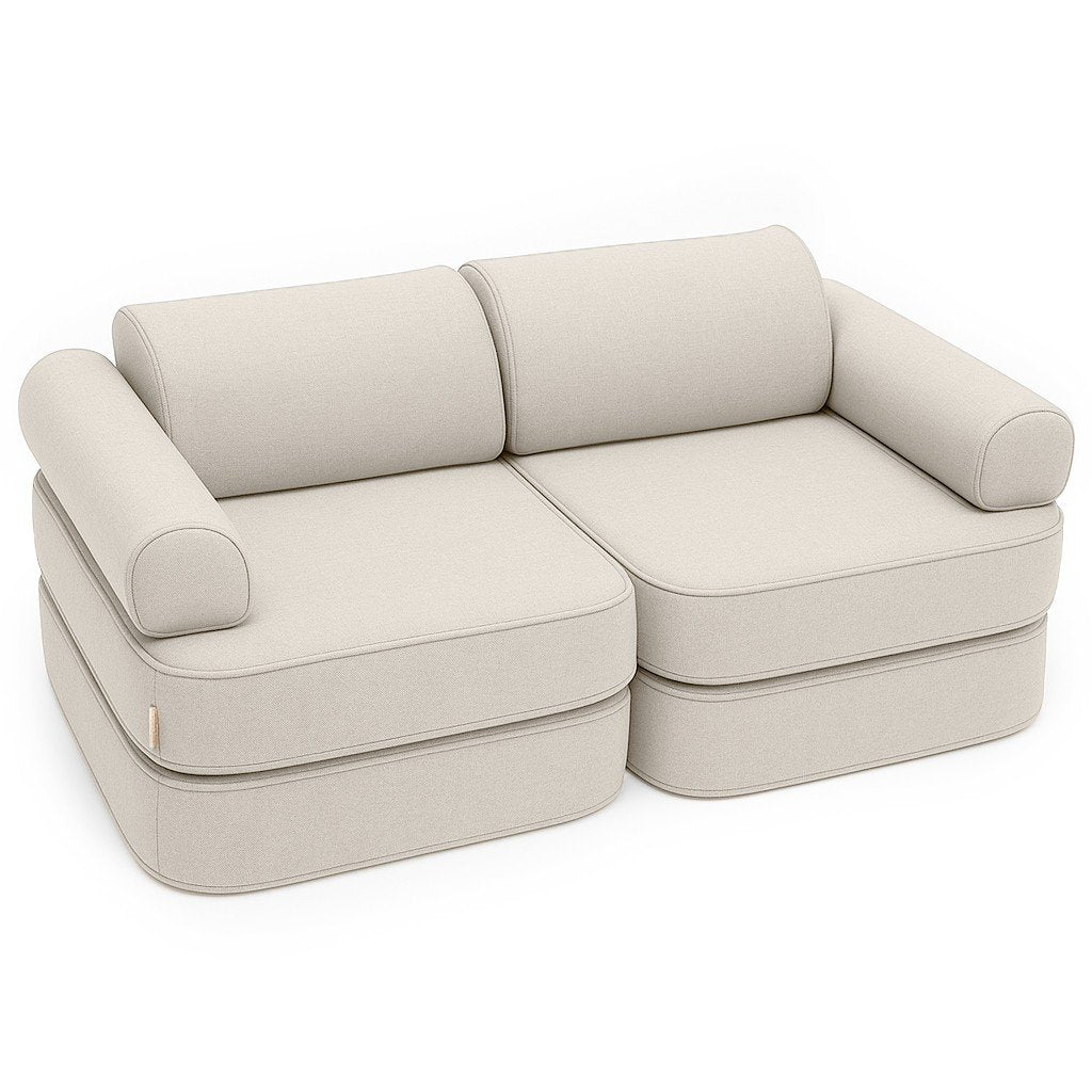 1. Children's modular sofa in oat blush beige with two double mattresses, two headrests, and two armrests, shown in a studio setting