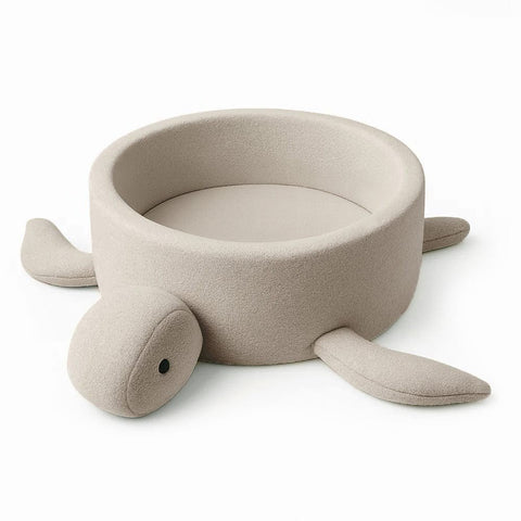 1. Beige turtle-shaped foam baby ball pit with boucle fabric and soft fins, shown empty on a white background
