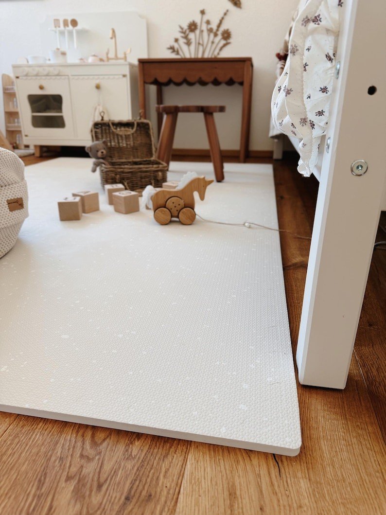 2. Scandinavian-style nursery with OLYA KIDS cashmere spots playmat, wooden toys, and wicker basket on wooden floor