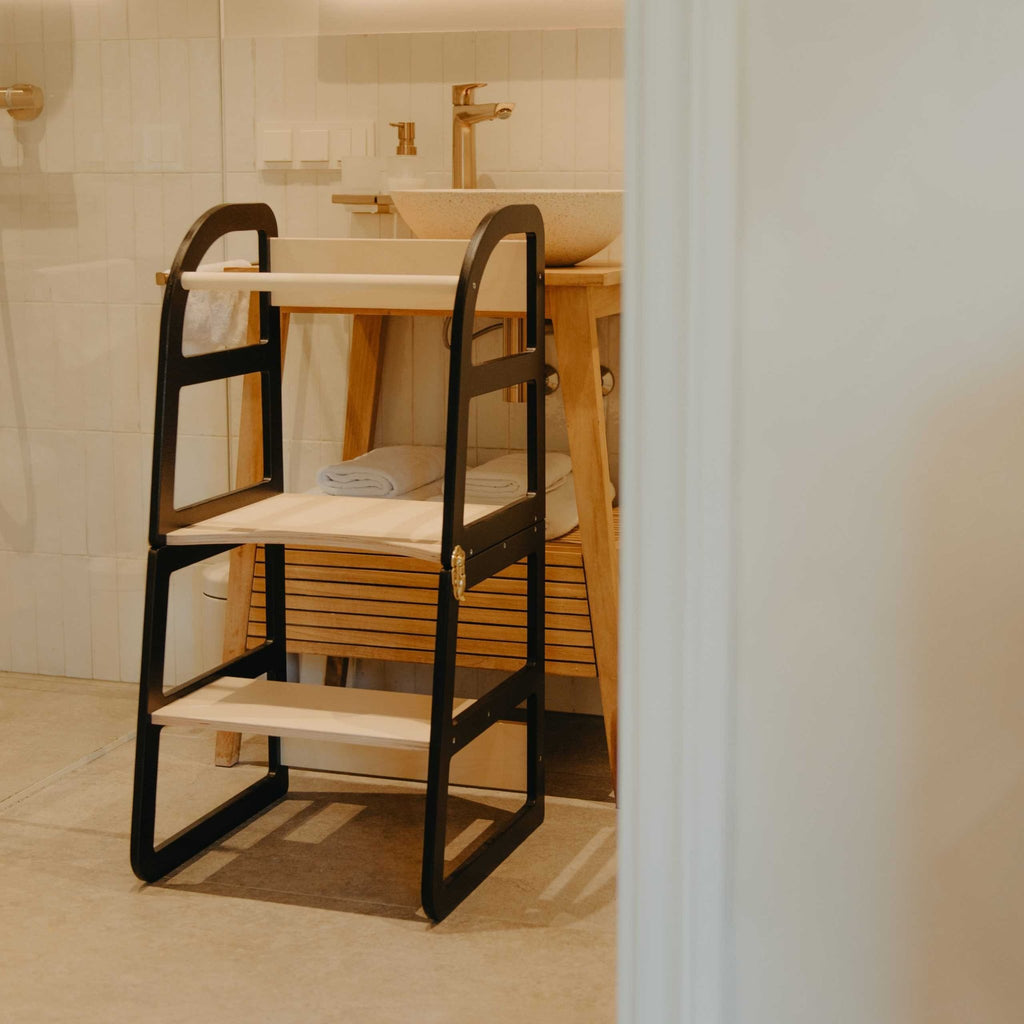 15. Black kitchen tower in bathroom setting with wooden accents